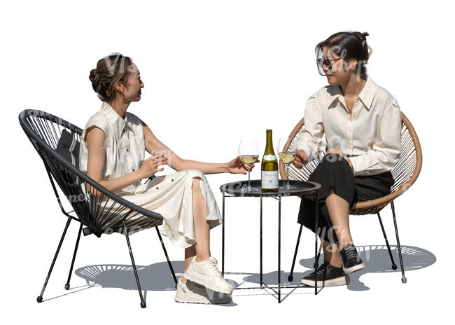 two asian women sitting in a cafe and drinking wine