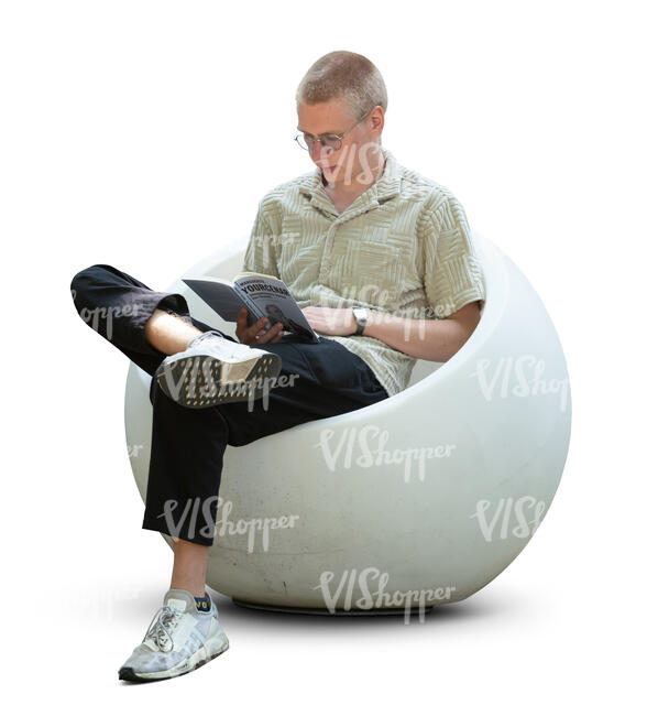 young man sitting in a modern armchair and reading a book