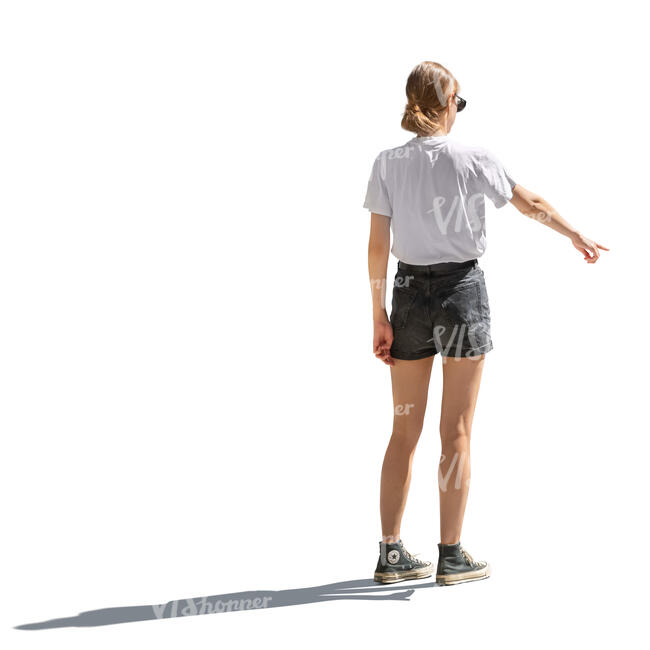 backlit young woman pointing at smth