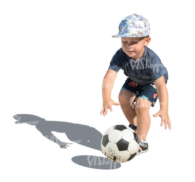 little boy playing with a football