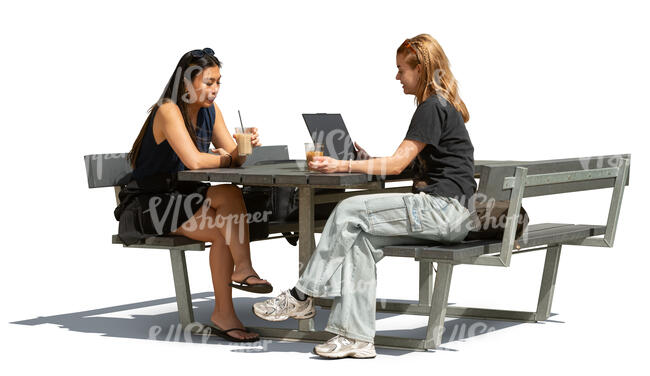 two female college students sitting outside with coffee and laptop