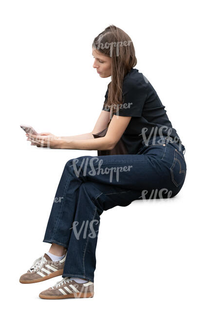 young woman sitting and looking at her phone