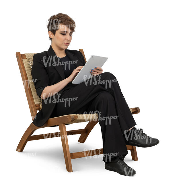 woman in a black costume sitting and reading a tablet
