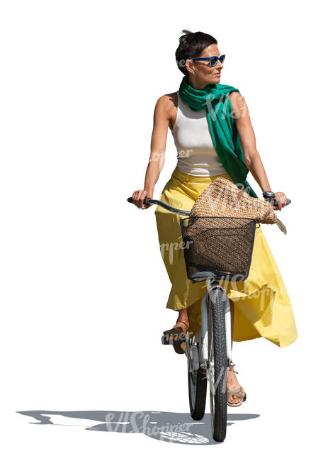 woman in a dress riding a bike on a sunny day