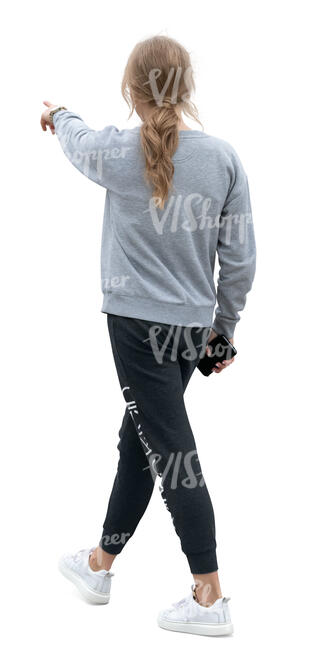 woman in joggers walking and pointing at smth
