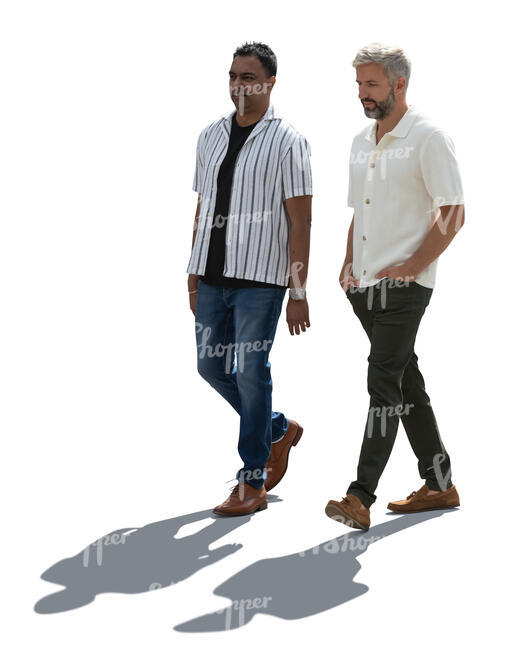 two backlit men walking together