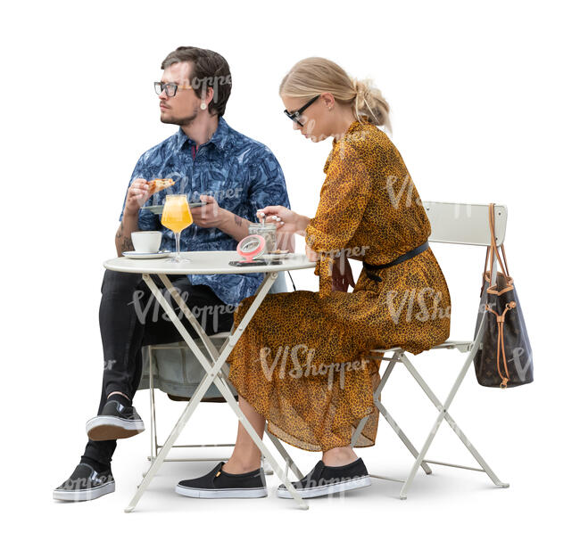 man and woman sitting in a cafe and eating