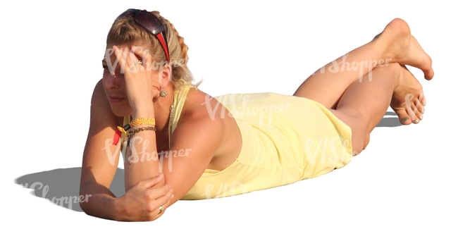 woman in a yellow dress lying on the beach