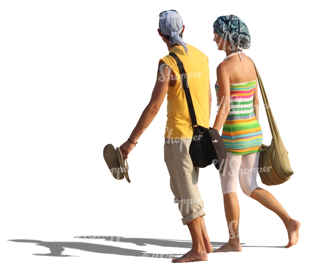 couple walking barefoot on the beach