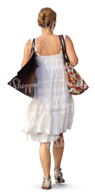 woman in a white dress carrying a shopping bag