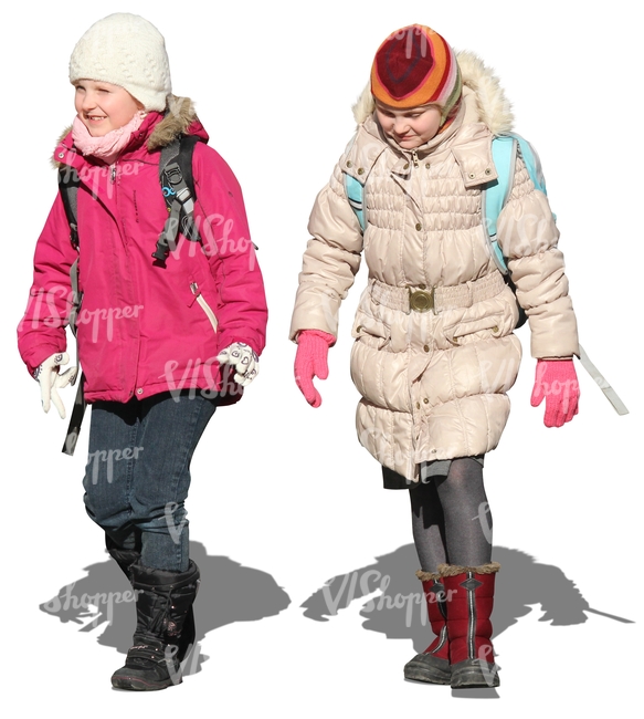 two girls with schoolbags walking in winter