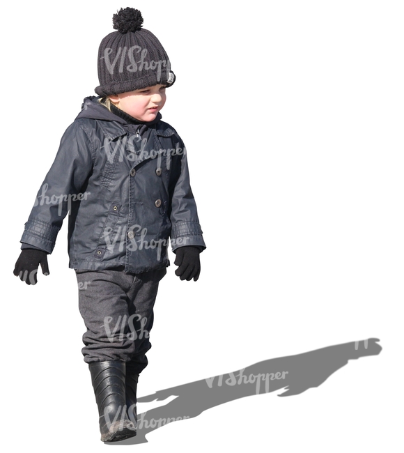 small boy in a black jacket walking