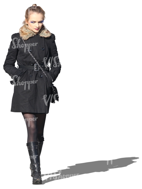 cut out woman in a black coat walking