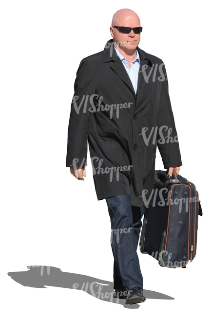 man in a black coat carrying a suitcase