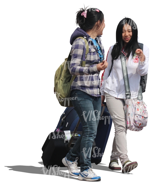 two asian women walking with suitcases