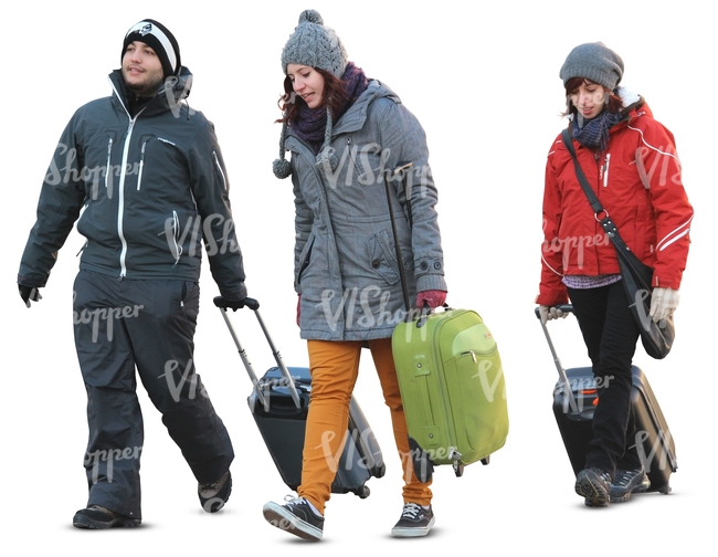 three people carrying suitcases in winter