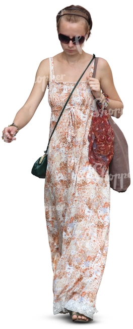 cut out woman in a long summer dress walking