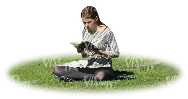 woman sitting on the grass and reading a book