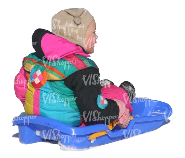 little girl sitting on a sledge