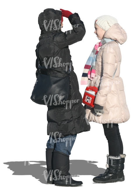 two cut out women in winter coats talking
