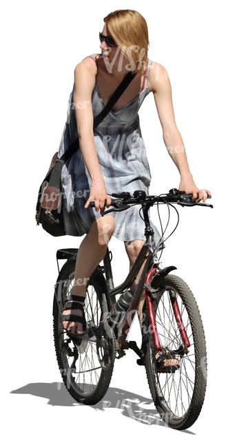 woman in a dress riding a bike