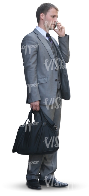 businessman with a bag standing an talking on the phone