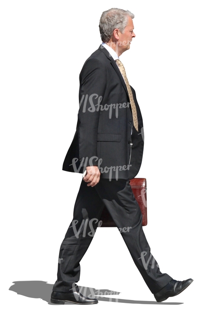 older businessman walking with a briefcase in his hand