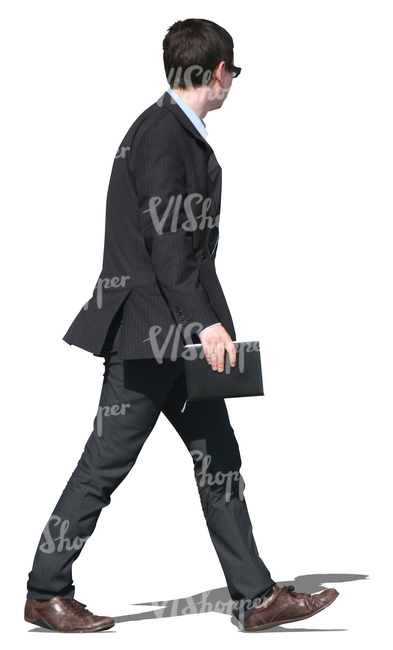 young businessman in a black suit walking