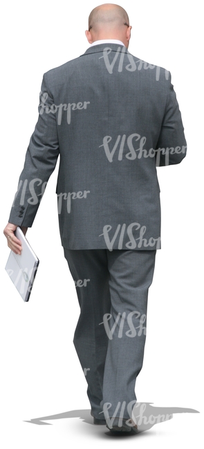 businessman walking with a notebokk in his hand