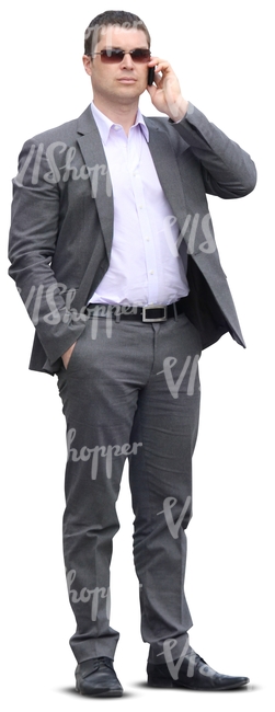 businessman in a grey suit talking on the phone