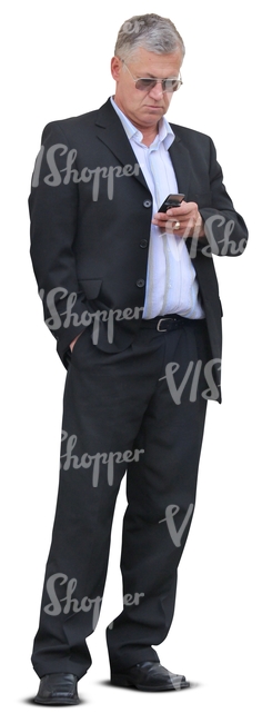 businessman standing and looking at his phone