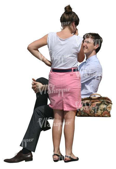 woman standing and talking to a sitting man