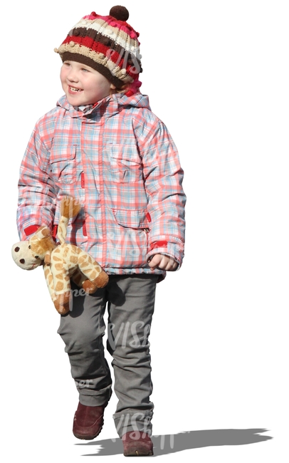 smiling girl walking with a toy in her hand