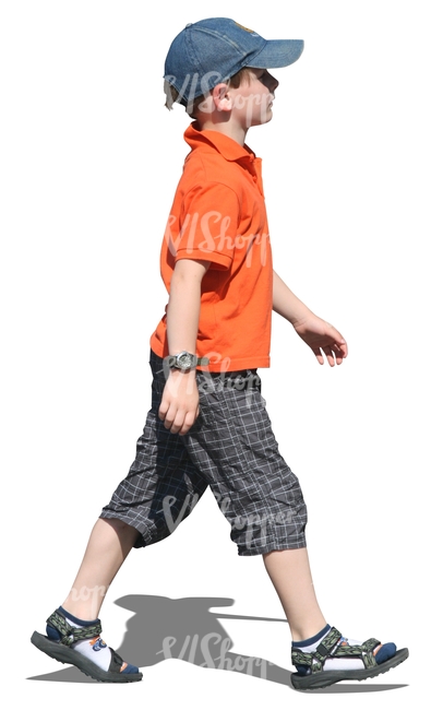 young boy with a baseball cap walking