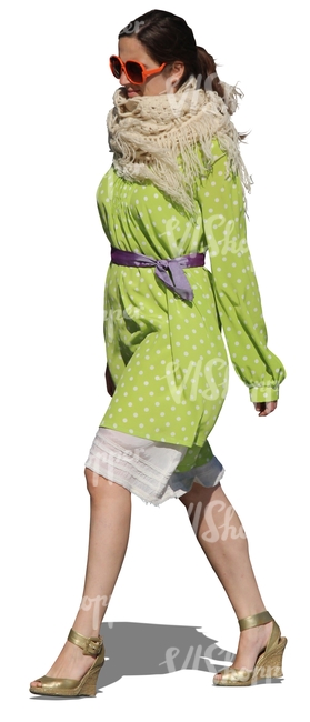 cut out woman in a green dress walking