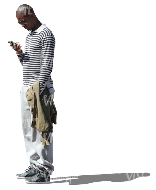 cut out black man standing and looking at his phone