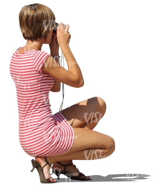 cut out woman squatting and taking a picture