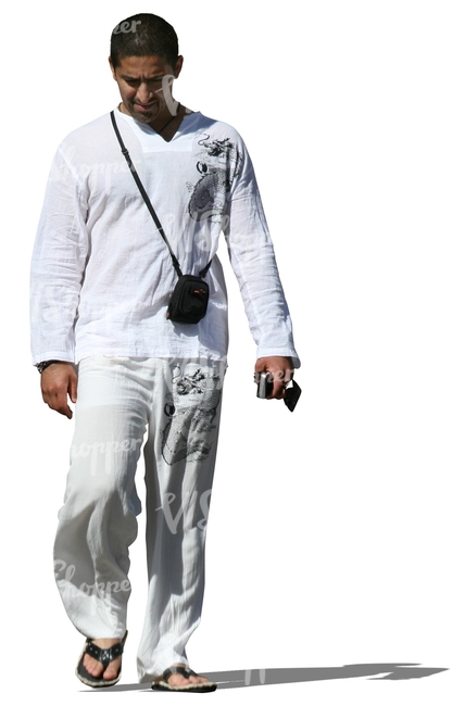 man in white summer clothes walking