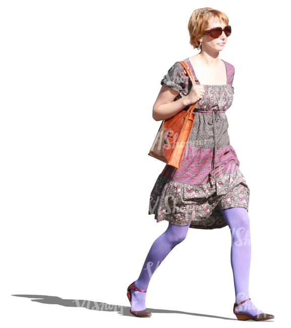 woman in a colorful dress walking hasttily