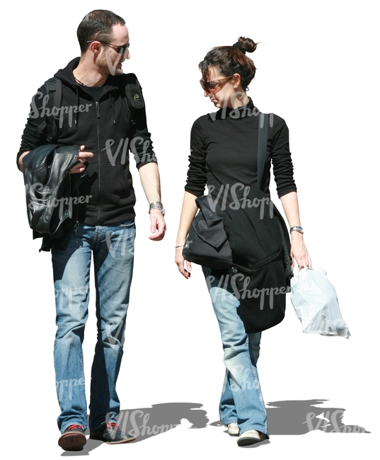 couple wearing jeans walking and talking