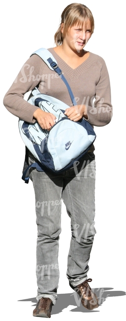 woman walking and looking in her backpack