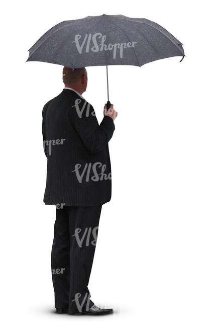 man in a black suit standing under an umbrella