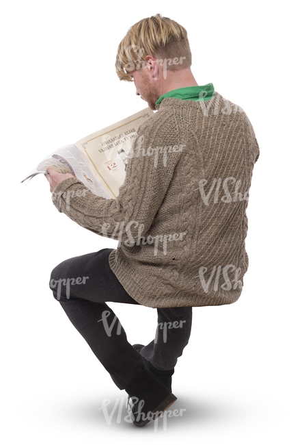 man sitting and reading a newspaper