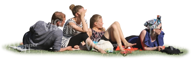 group of four people sitting on the grass