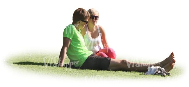 man and woman sitting on the grass