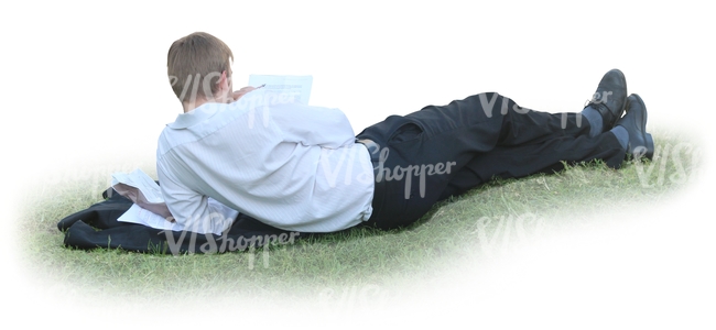 businessman lying on the grass and reading