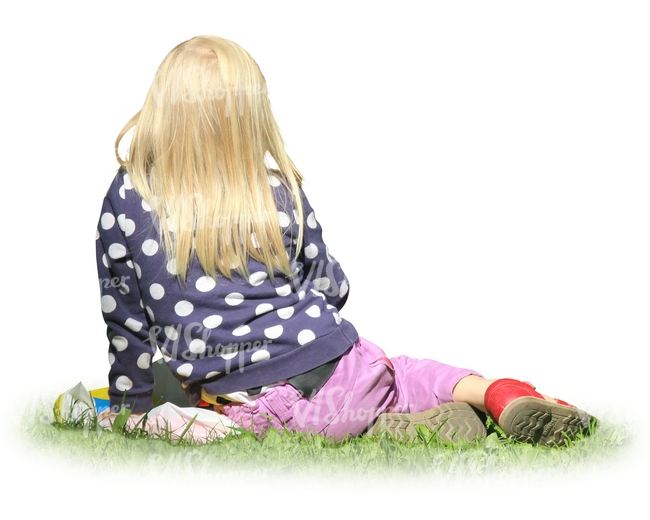 blond young girl sitting on the grass