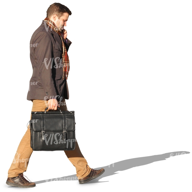 man with a suitcase walking and talking on the phone