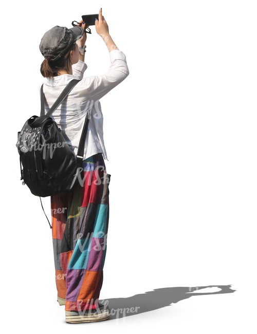 woman with a backpack standing and taking a picture