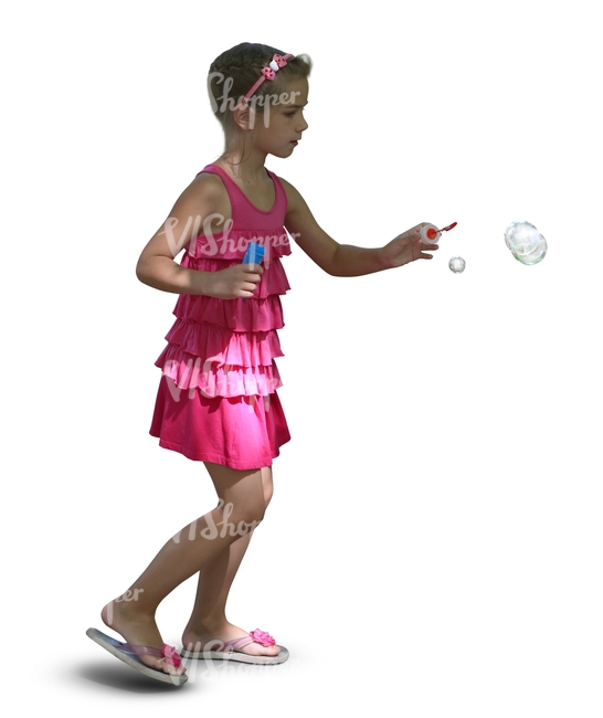 young girl in a pink dress playing with soap bubbles